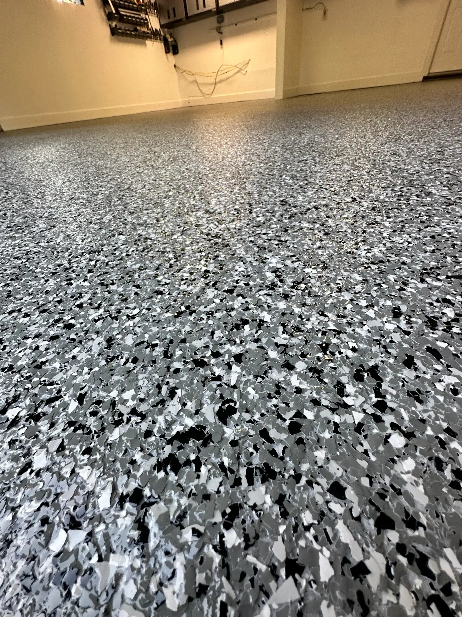 Detailed granite hybrid flake concrete floor finish for an Ada MI home