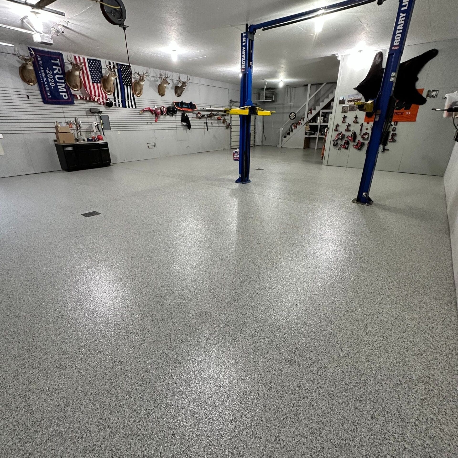 Granite-look hybrid flake flooring selected for a refined Ada Michigan interior