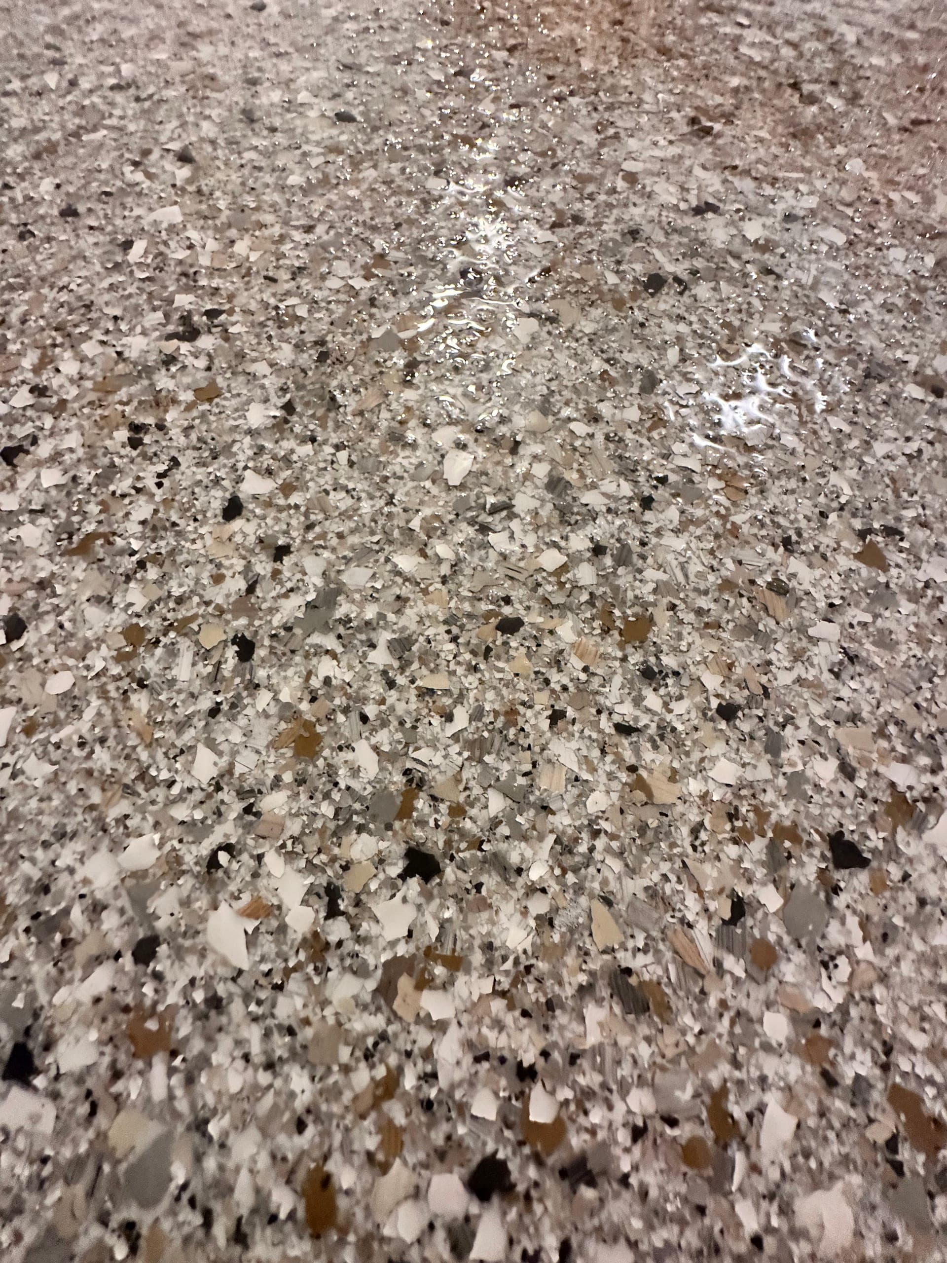 Designer hybrid flake flooring with a stone-inspired pattern in West Michigan