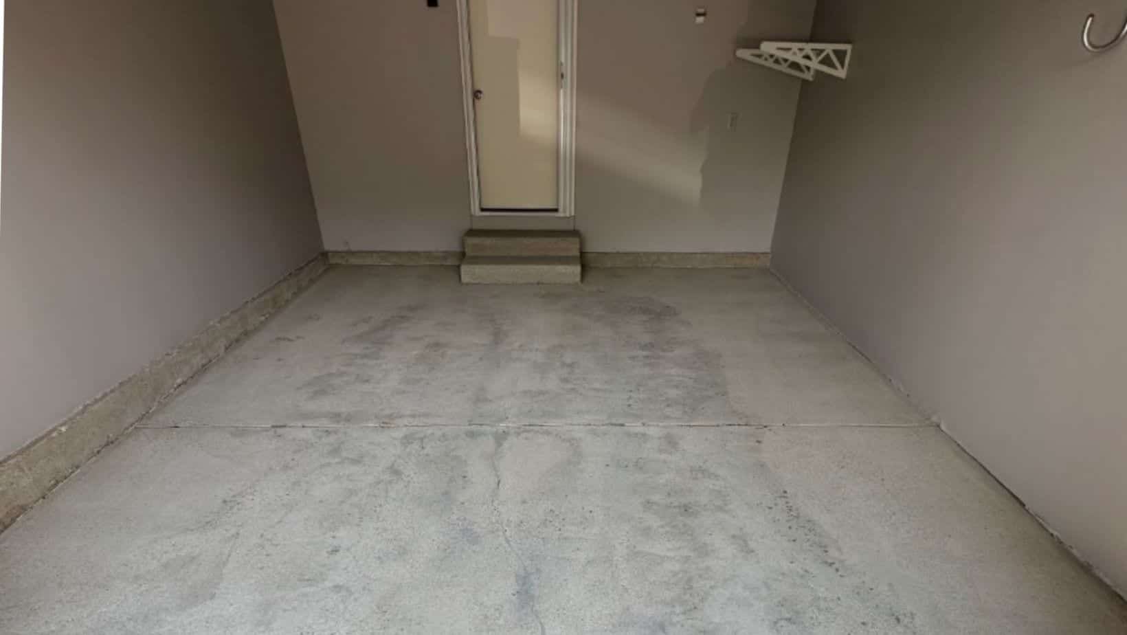 Bare basement concrete before floor preparation