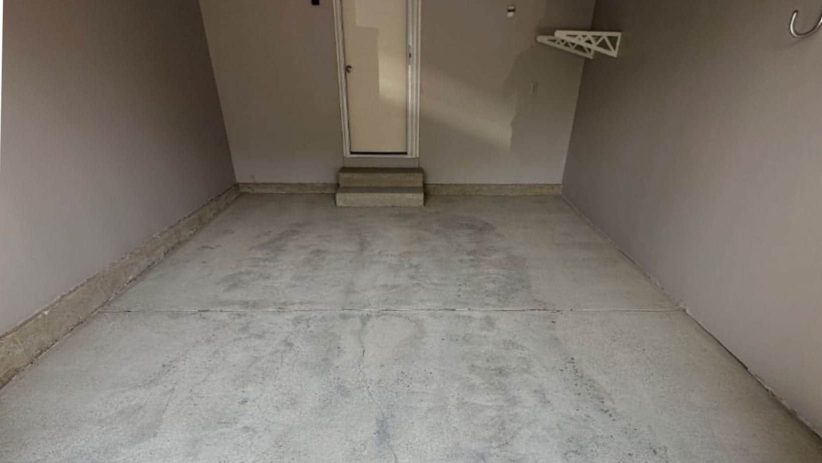 Bare basement concrete floor before surface preparation