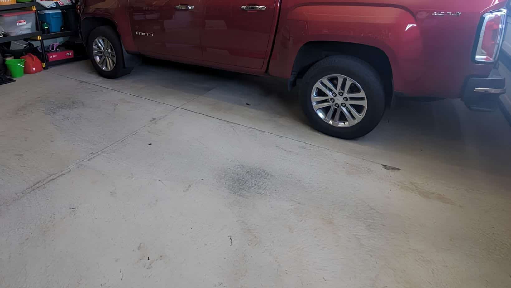 Worn garage slab with visible cracks before coating preparation
