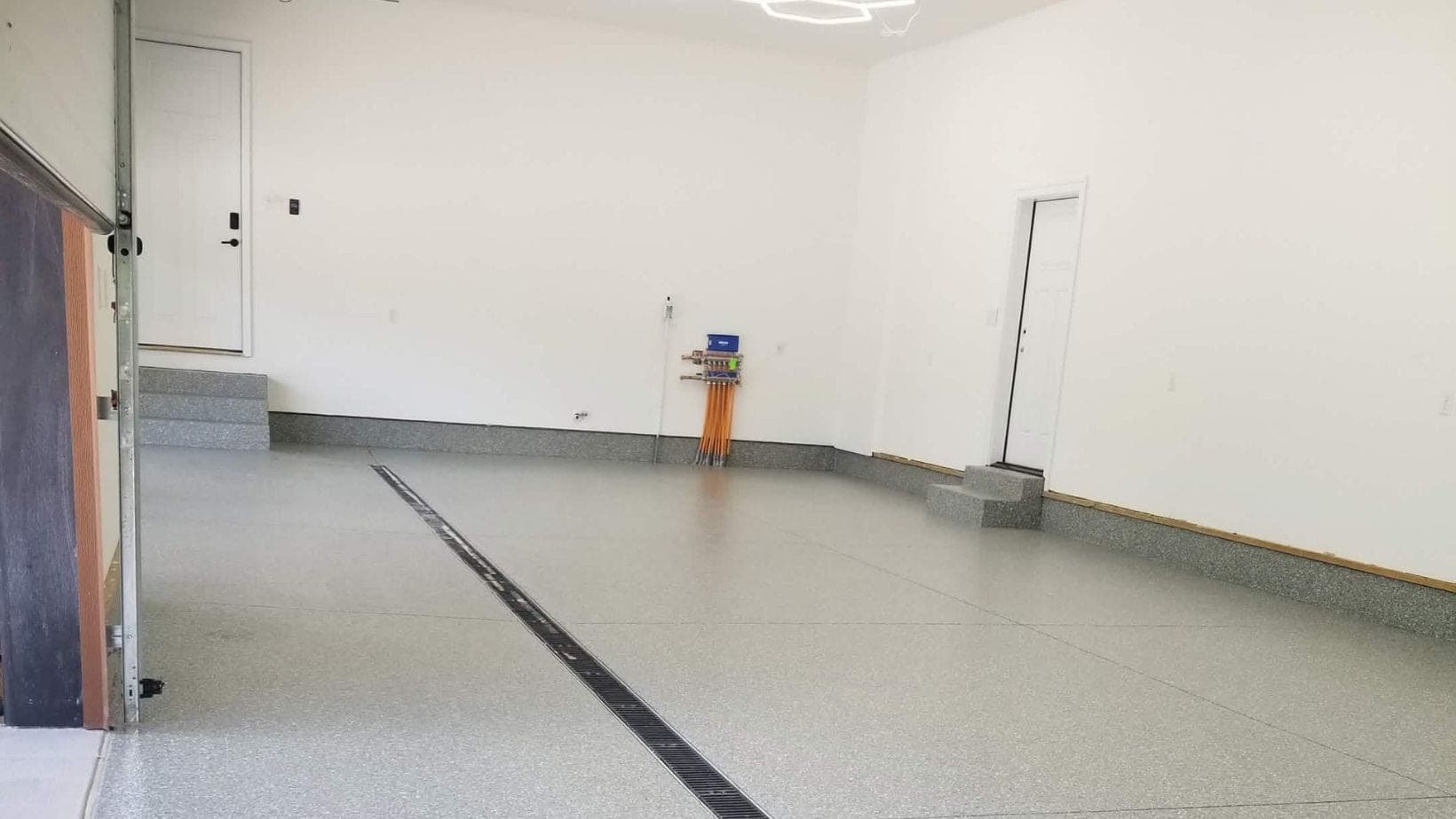 Speckled flake coating across an oversized West Michigan garage floor