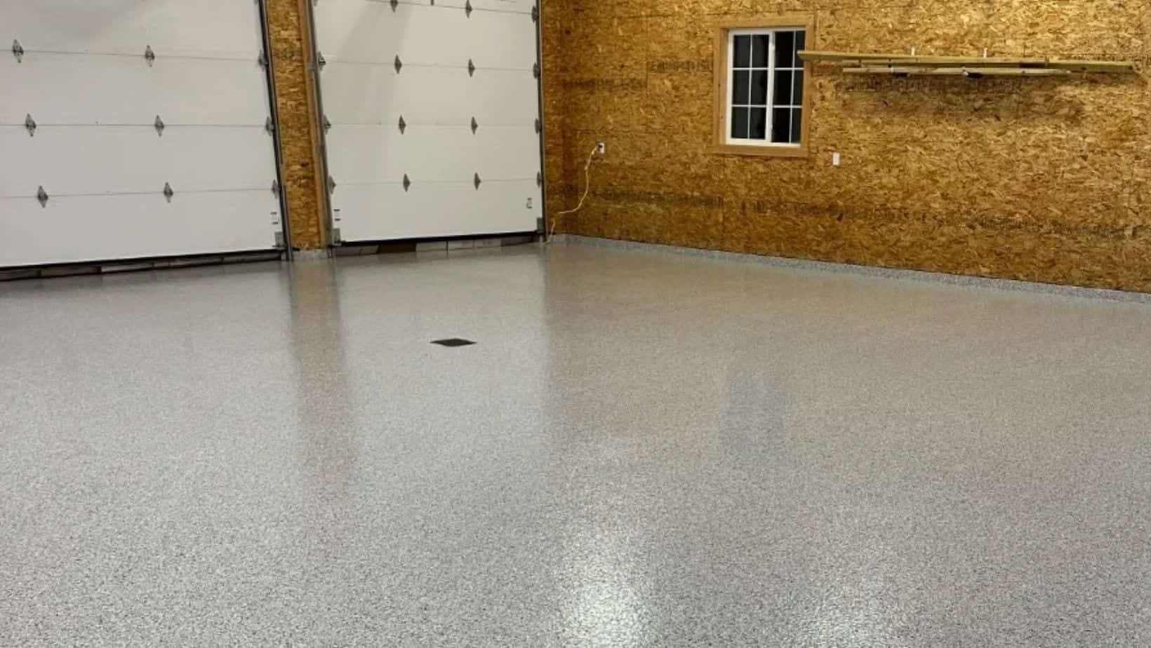 Gray flake epoxy flooring installed in a Middleville Michigan pole barn