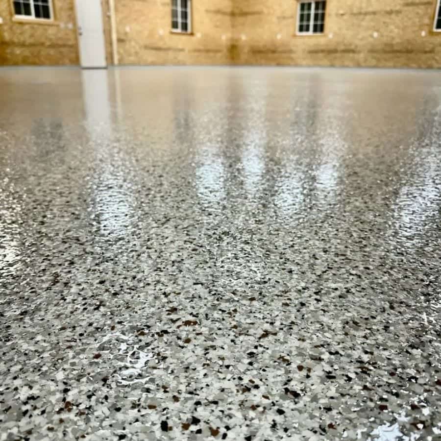 Close view of a glossy polyaspartic topcoat over decorative flake