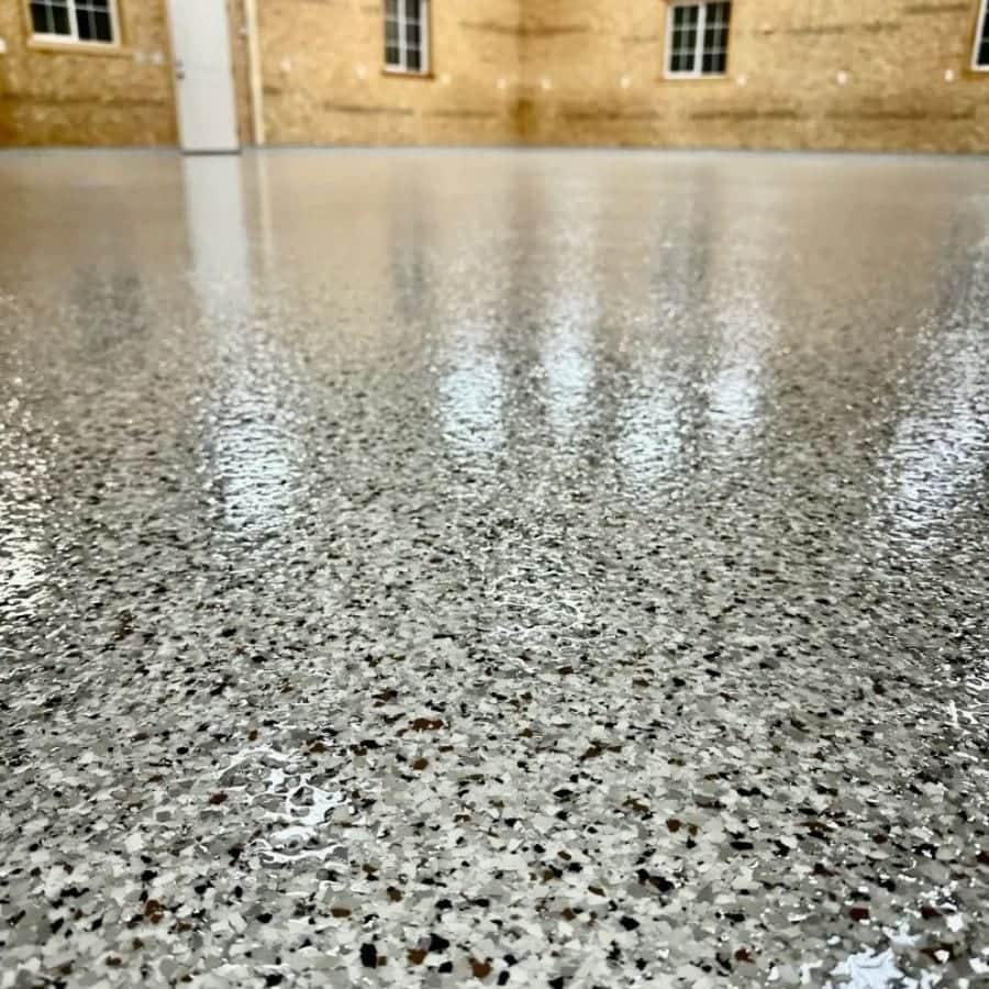 Close view of a glossy polyaspartic topcoat over decorative flake