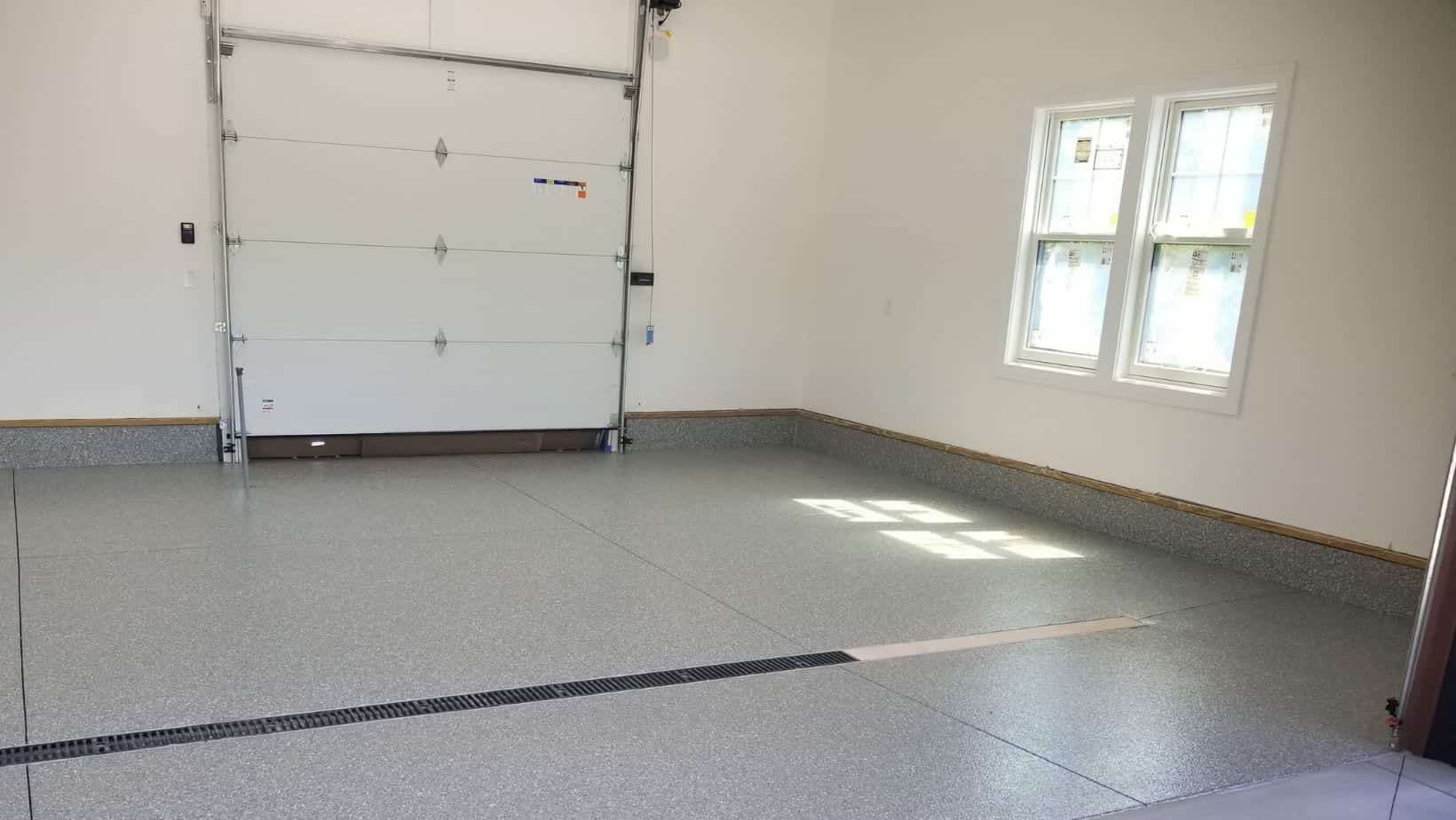 Light gray flake coating across a completed single-car garage