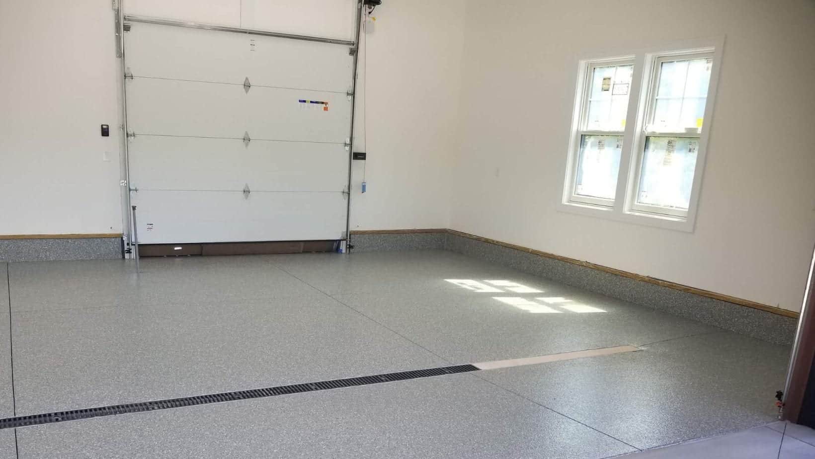 Light gray flake coating across a completed single-car garage