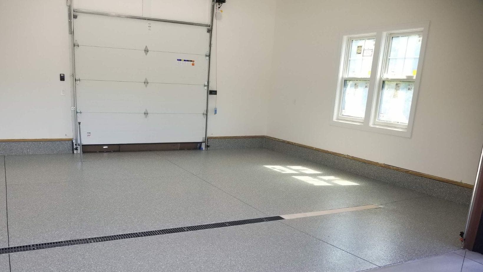 Light gray single-car garage coating for a Comstock Park condo