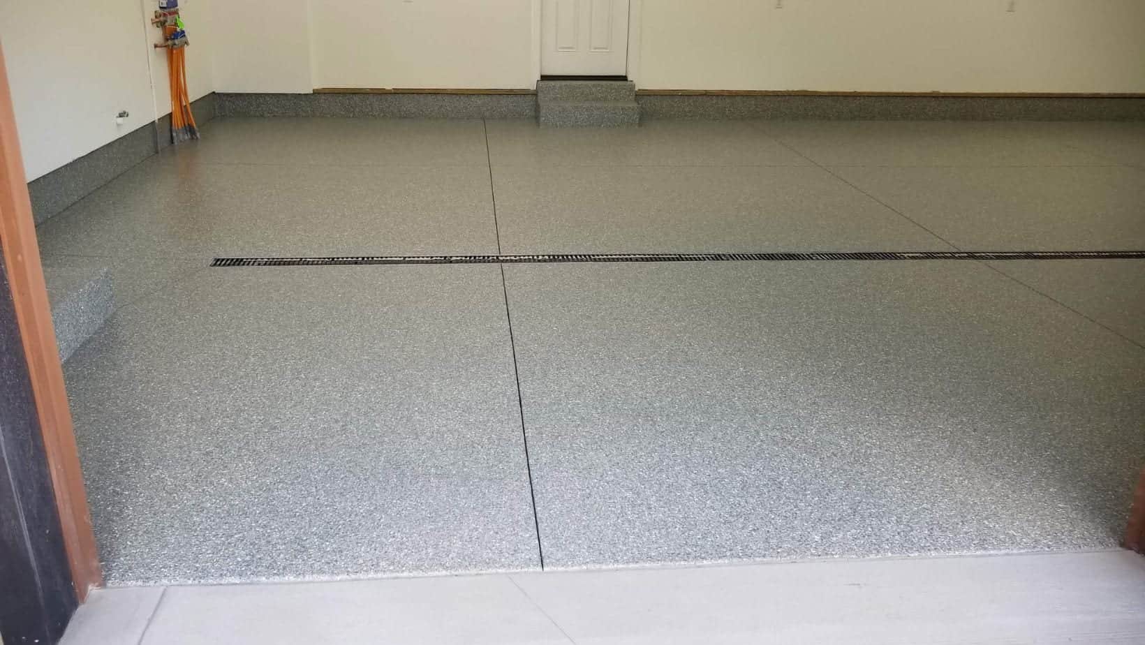 Gray flake coating across a finished two-car garage floor