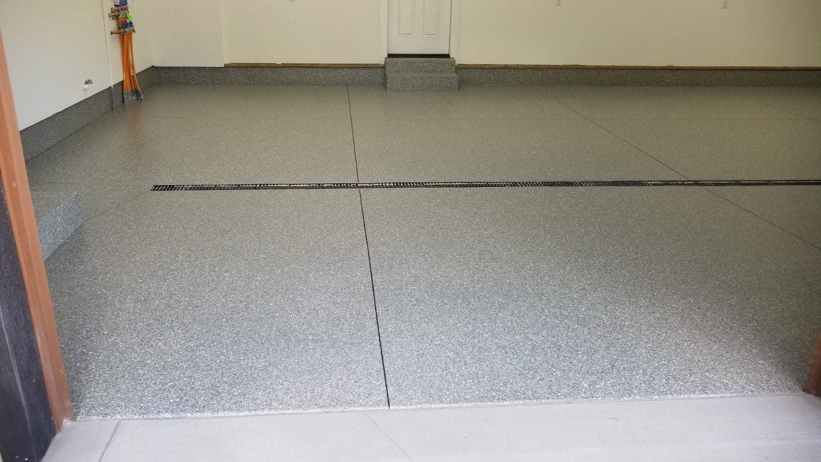 Gray flake two-car garage floor suitable for a Comstock Park ranch